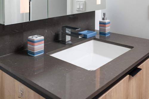 a kitchen counter with a sink and a faucet at North End TD Garden Condo Shared Pool & Rooftop in Boston