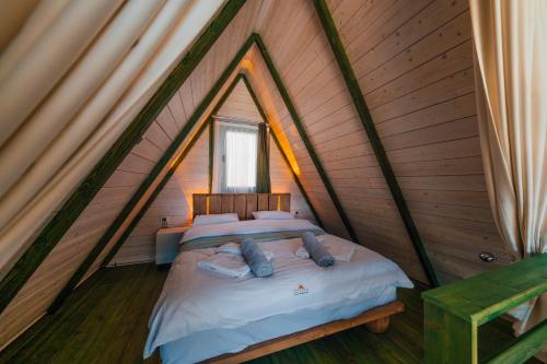 a bedroom with a bed in a triangular room at tetova in Sapanca