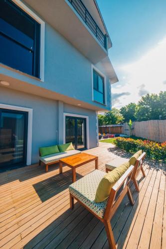 a wooden deck with benches and tables on a house at tetova in Sapanca