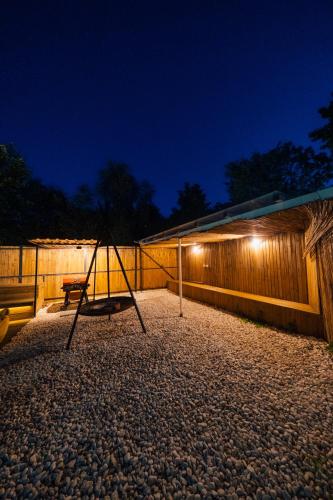 a swing sitting on a gravel patio at night at tetova in Sapanca