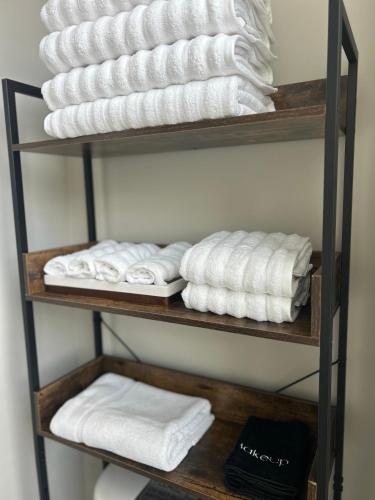 a bunch of towels are stacked on a shelf at 1280 Bungalow in Atlanta