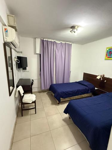 Ένα ή περισσότερα κρεβάτια σε δωμάτιο στο Hotel Nuevo Premier