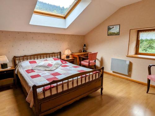 a bedroom with a bed and a skylight at Grande maison au cœur des Vosges, escapades et nature - FR-1-583-466 in Belfahy