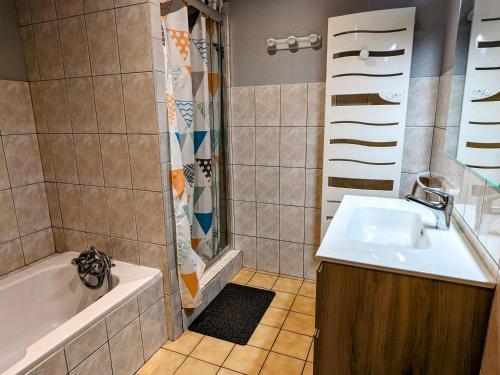 a bathroom with a sink and a shower and a tub at Grande maison au cœur des Vosges, escapades et nature - FR-1-583-466 in Belfahy