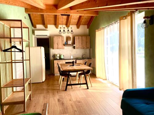 a kitchen with a wooden table and a refrigerator at Ca' Celeste sul Garda in Costermano sul Garda