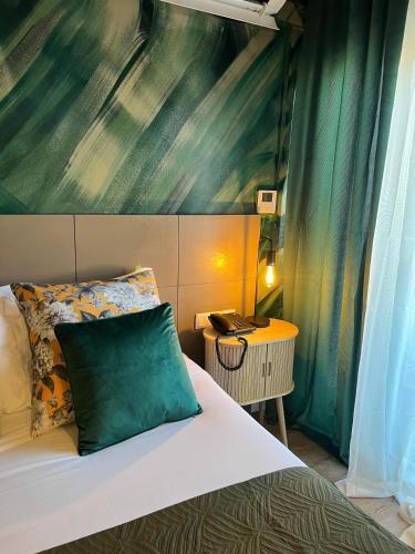 a bedroom with a bed with a green wall at BE ONE HOTEL Caldas da Rainha - by MHMB Hospitality in Caldas da Rainha