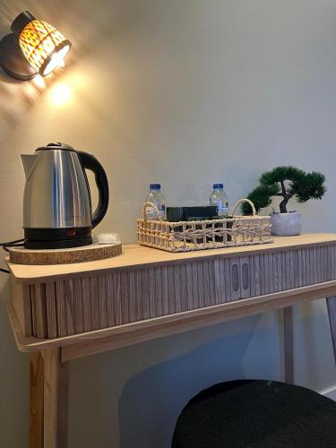 a table with a tea kettle and other items on it at BE ONE HOTEL Caldas da Rainha - by MHMB Hospitality in Caldas da Rainha
