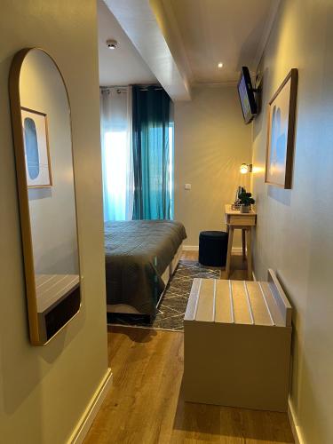 a small room with a bed and a mirror at BE ONE HOTEL Caldas da Rainha - by MHMB Hospitality in Caldas da Rainha