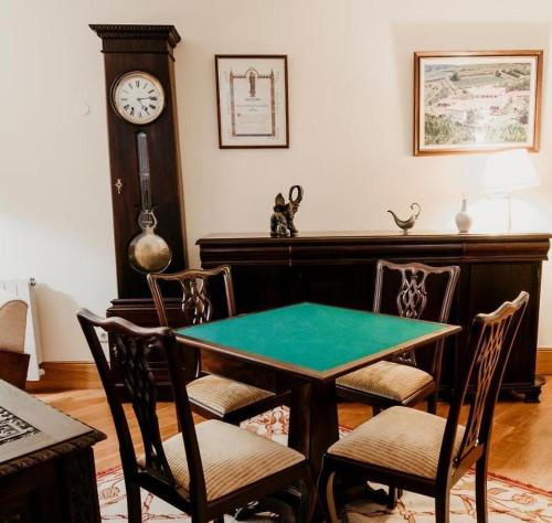 a dining room with a table and a grandfather clock at Perre Rural House in Perre