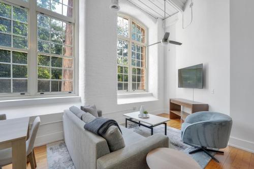 a living room with a couch and a table at Landing Stylish 1BD Yoga Studio Gym in Greenville