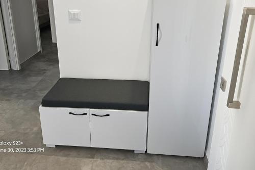 a white cabinet with a black counter top at Luxurious apartment Lina in Hiboun