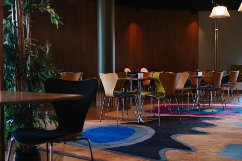 a group of tables and chairs in a room at Clarion Hotel Energy in Stavanger