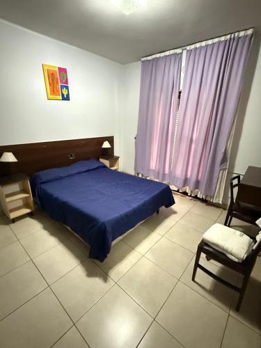 Ένα ή περισσότερα κρεβάτια σε δωμάτιο στο Hotel Nuevo Premier
