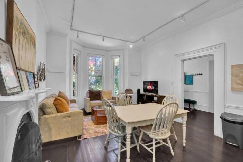 a dining room and living room with a table and chairs at Cozy 1 Bed Apt Mins to Downtown and Beach Parking in Cobourg