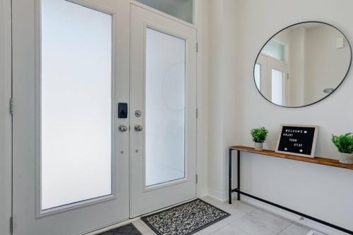 a hallway with a door and a mirror at Stylish 3BDR in Pickering Heart Free Parking in Pickering