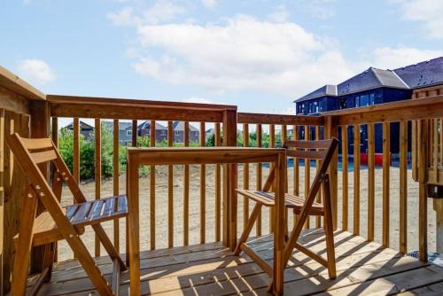 two chairs sitting on the deck of a cabin at Stylish 3BDR in Pickering Heart Free Parking in Pickering