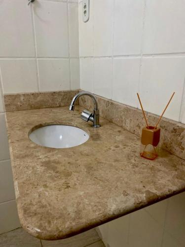 a bathroom counter with a sink with two straws on it at Hostel Wei in Boa Vista