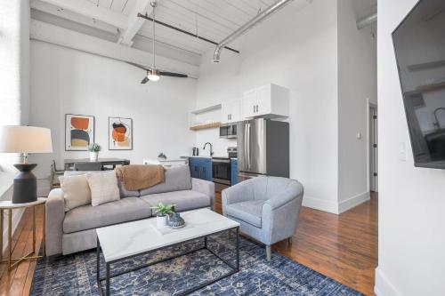 a living room with a couch and a chair and a table at Landing Stylish 1BD Yoga Studio Gym in Greenville