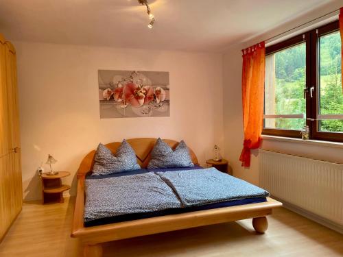 a bedroom with a bed and a window at Haus am Erzbach - Ferienwohnung mitten in der Natur in Eisenerz