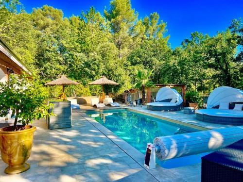 a swimming pool with blue inflatables and trees at La Casa dei Sogni in Flayosc