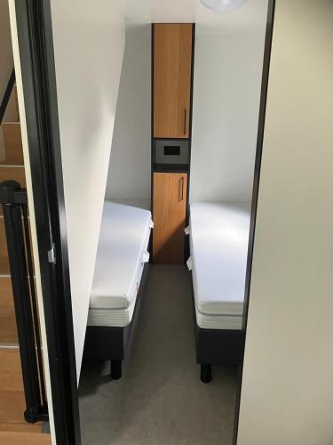 a small room with two white bunk beds at Prinsenweg 1 tm 4 in Nijkerk