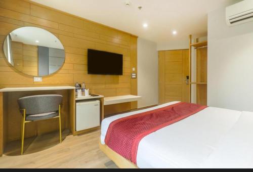 a bedroom with a bed and a sink and a mirror at Hotel Bella family Atmoshere New Delhi in New Delhi