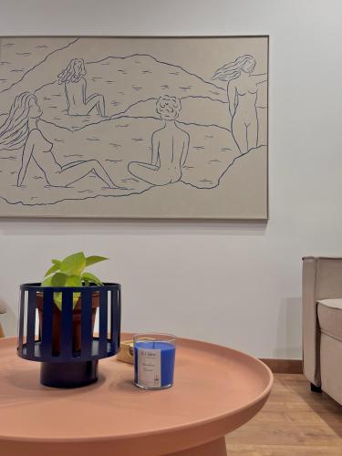 a table with a drawing of people sitting on a beach at RomanRest in Loutra Edipsou