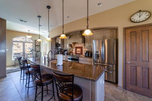 a kitchen with a large island with bar stools at Majestic Mountain Escape-hike trails from backyard in Albuquerque