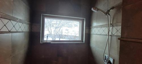 a bathroom with a window and a shower in it at Majestic Mountain Escape-hike trails from backyard in Albuquerque