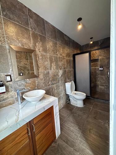 a bathroom with a sink and a toilet in it at Hotel Boutique Casa Zafra in Campeche