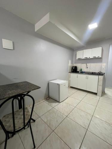 a kitchen with a counter and a table in a room at Estúdio 101 - 10 minutos da rodoviária e aeroporto in Brasilia