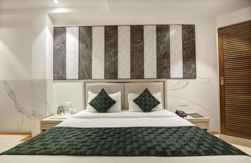 a bedroom with a large bed in a room at Hotel Bella family Atmoshere New Delhi in New Delhi