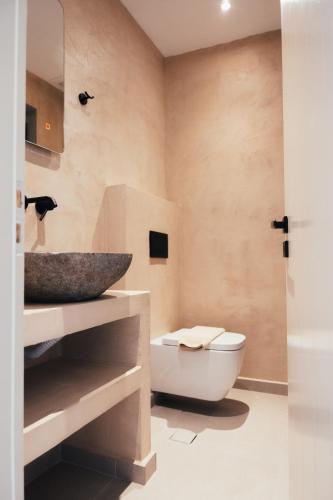a bathroom with a sink and a toilet at Marmari Paradise Resort Hotel in Marmari