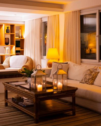 a living room with a couch and a coffee table at La Chimère Buzios Essence in Búzios