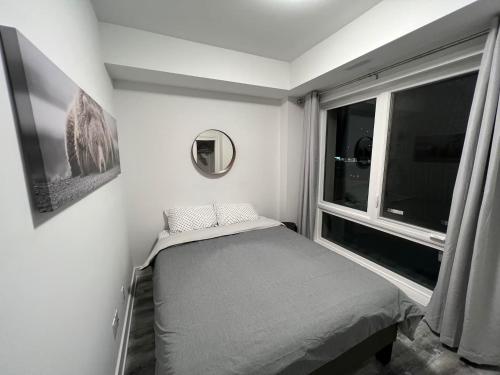 a small bedroom with a bed and a window at 2 Bed Town ideal for a fun-filled family vacation in Niagara Falls
