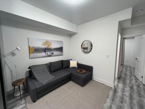 a living room with a black couch and a table at 2 Bed Town ideal for a fun-filled family vacation in Niagara Falls