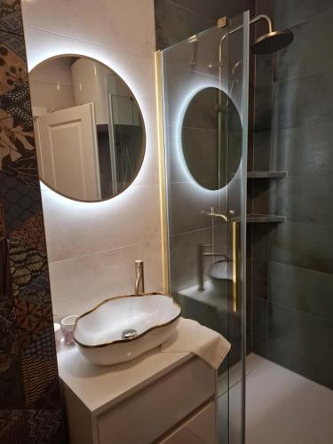 a bathroom with a sink and a mirror at Apartman JAMI in Spišské Podhradie