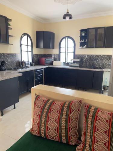 a kitchen with blue cabinets and a couch in a room at villa Oasis Rouge Sable in Marrakech