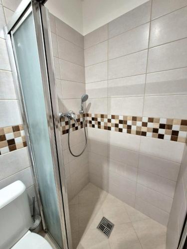 a shower with a glass door in a bathroom at Apartmány v srdci Ružinova in Trnávka