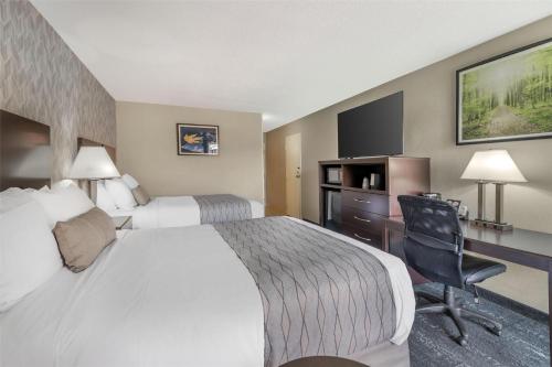 a hotel room with a bed and a desk at Best Western Plus Keene Hotel in Keene