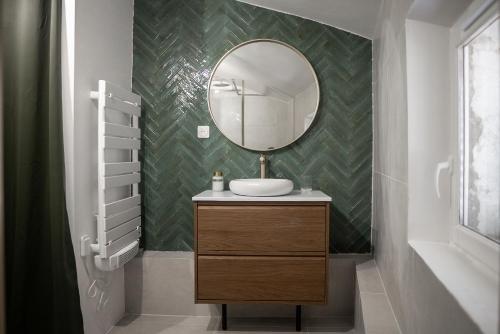 a bathroom with a sink and a mirror at Play & Chill - Loft Cosy in Hyères
