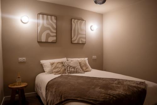 a bedroom with a bed with three pictures on the wall at Play & Chill - Loft Cosy in Hyères