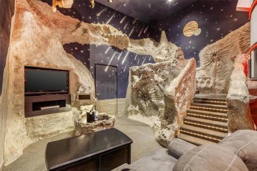 a living room with a rock wall and a tv at Best Western Fireside Inn in Kingston