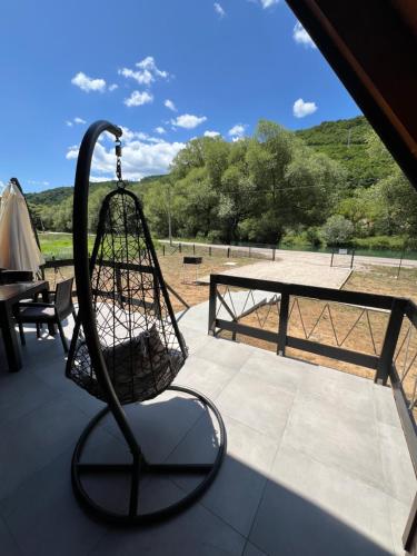 a swing on top of a patio with a table at Vila Jezero-Jajce in Jezero
