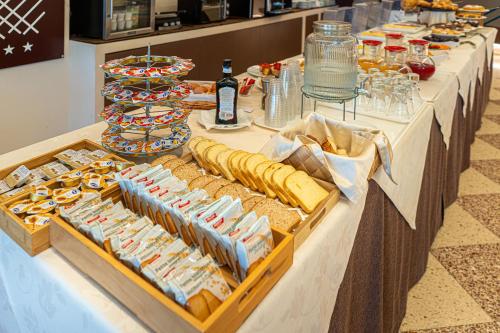 a table with a buffet of sandwiches and bread at Al Pescatore Suites in Cefalù