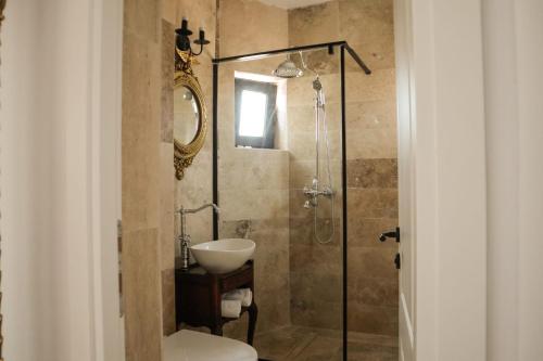 a bathroom with a shower with a toilet and a sink at Konac Regesc in Eforie Sud