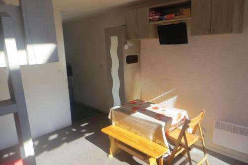 a stack of boxes sitting on a chair in a room at Appart 5 pers, pied des pistes à Piau-Engaly, au coeur de la station in La Celle-sous-Gouzon