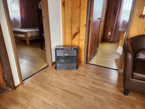 a hallway with a room with a television on the floor at Cabañas Kernayel in Pucón