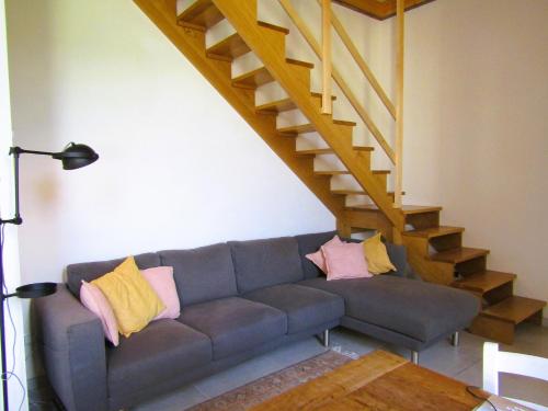 a living room with a couch and a staircase at Il Tulipano in Camaiore