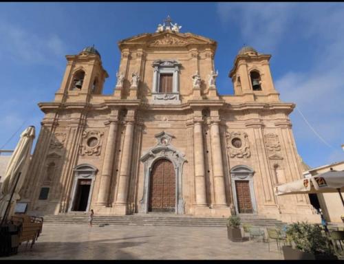 a large church with stairs in front of it at Casa Vacanze Regina in Marsala
